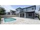 A backyard with a pool, patio, and neighboring homes is perfect for outdoor relaxation and entertainment at 9917 Summerlake Groves St, Winter Garden, FL 34787