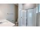 Bathroom with white tile shower, a vanity with sink, and a toilet at 9917 Summerlake Groves St, Winter Garden, FL 34787