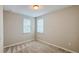 Cozy bedroom with carpeted floors, neutral walls, and natural light from two windows at 9917 Summerlake Groves St, Winter Garden, FL 34787