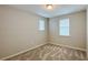 Carpeted bedroom showcasing neutral walls, trim and carpeting with two windows providing natural light at 9917 Summerlake Groves St, Winter Garden, FL 34787