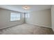 Spacious bedroom features neutral walls, carpeted floors, and two windows allowing lots of sunlight at 9917 Summerlake Groves St, Winter Garden, FL 34787