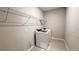 Bright laundry room featuring a washer, dryer, wire shelving and tile flooring at 9917 Summerlake Groves St, Winter Garden, FL 34787