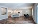 Bright open-concept living space features hardwood floors, a kitchen island, dining area, and patio doors at 9917 Summerlake Groves St, Winter Garden, FL 34787