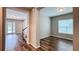Bright open-concept living space boasts hardwood floors, a staircase, and access to an outdoor area with a pool at 9917 Summerlake Groves St, Winter Garden, FL 34787