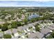 Scenic aerial view of the neighborhood showcasing a tranquil pond and lush greenery at 10125 Sandy Marsh Ln, Orlando, FL 32832