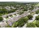 Bird's eye view of a residential area featuring lush greenery, manicured lawns, and a lake at 10125 Sandy Marsh Ln, Orlando, FL 32832