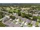 Aerial view of a community with well-manicured lawns and a golf course in the background at 10125 Sandy Marsh Ln, Orlando, FL 32832