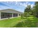Spacious, well-maintained backyard with lush lawn, mature trees, and screened-in lanai at 10125 Sandy Marsh Ln, Orlando, FL 32832