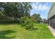 Spacious backyard featuring a well-maintained lawn, lush landscaping, and mature trees, perfect for outdoor enjoyment at 10125 Sandy Marsh Ln, Orlando, FL 32832