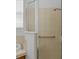 Bathroom featuring tile shower with glass door and handrail at 10125 Sandy Marsh Ln, Orlando, FL 32832