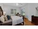 Bright bedroom with hardwood floors, desk, and sliding glass doors leading to the outdoors at 10125 Sandy Marsh Ln, Orlando, FL 32832