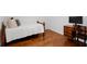 Bedroom with a comfortable single bed, desk and wood floors with bright natural light at 10125 Sandy Marsh Ln, Orlando, FL 32832