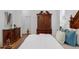 Well-lit bedroom showcasing hardwood floors, large furniture and a comfortable bed at 10125 Sandy Marsh Ln, Orlando, FL 32832