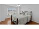 Comfortable bedroom with natural light, hardwood floors, and a ceiling fan at 10125 Sandy Marsh Ln, Orlando, FL 32832