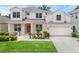 Charming two-story home featuring a well-manicured lawn and inviting front entrance at 10125 Sandy Marsh Ln, Orlando, FL 32832