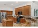 Gourmet kitchen featuring granite countertops, stainless steel appliances, and wood cabinets at 10125 Sandy Marsh Ln, Orlando, FL 32832