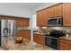 Kitchen features granite countertops, stainless steel appliances, and wood cabinetry at 10125 Sandy Marsh Ln, Orlando, FL 32832