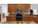 Kitchen showcasing granite countertops, stainless steel appliances, and wood cabinetry at 10125 Sandy Marsh Ln, Orlando, FL 32832