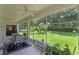 Relaxing screened lanai with ceiling fans and views of the backyard and landscaping at 10125 Sandy Marsh Ln, Orlando, FL 32832