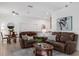 Spacious living room with vaulted ceilings, leather sofas, and a cozy rug at 10125 Sandy Marsh Ln, Orlando, FL 32832