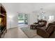 Relaxing living room showcasing leather sofas, and view of an outdoor patio at 10125 Sandy Marsh Ln, Orlando, FL 32832