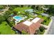 Beautiful aerial view highlighting the community pool, tennis courts, clubhouse, and surrounding greenery at 10169 Matchlock Dr, Orlando, FL 32821
