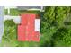 Aerial view of a home with a red tile roof, showcasing the backyard and surrounding landscaping at 10169 Matchlock Dr, Orlando, FL 32821