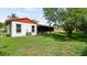 This house features a well-maintained backyard with lush green grass and a screened-in patio at 10169 Matchlock Dr, Orlando, FL 32821