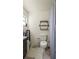 The bathroom features a toilet, hexagonal shelving, and a shower behind a gray curtain at 10169 Matchlock Dr, Orlando, FL 32821