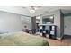 Bedroom with a sliding barn door, modern storage, and music rehearsal instruments at 10169 Matchlock Dr, Orlando, FL 32821