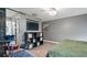 Cozy bedroom featuring a gray accent wall, modern storage, and a music rehearsal corner at 10169 Matchlock Dr, Orlando, FL 32821