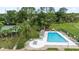 Aerial view showcasing the community pool, seating areas, and surrounding lush greenery at 10169 Matchlock Dr, Orlando, FL 32821