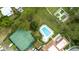 Aerial view of a community pool, basketball and tennis courts, surrounded by lush trees at 10169 Matchlock Dr, Orlando, FL 32821