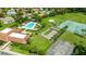 Aerial view showcasing the community pool, bocce ball and tennis courts, and parking lot at 10169 Matchlock Dr, Orlando, FL 32821