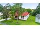 Charming home with a red tile roof, well-manicured lawn, and mature trees in a desirable neighborhood at 10169 Matchlock Dr, Orlando, FL 32821
