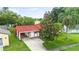 Beautiful home with a red tile roof, attached garage, and mature trees creating a welcoming atmosphere at 10169 Matchlock Dr, Orlando, FL 32821