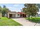 Charming single-story home features a red tile roof and a spacious front yard with mature trees at 10169 Matchlock Dr, Orlando, FL 32821