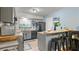 Modern kitchen featuring gray cabinetry, a convenient breakfast bar, and stylish black appliances at 10169 Matchlock Dr, Orlando, FL 32821