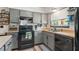 Updated kitchen featuring sleek gray cabinetry, modern appliances, and a stylish subway tile backsplash at 10169 Matchlock Dr, Orlando, FL 32821