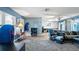 Spacious open concept living area with hardwood flooring, a couch, and a separate seating area by the windows at 10169 Matchlock Dr, Orlando, FL 32821