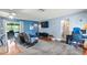 Living area features hardwood floors, comfy seating, and sliding glass doors leading to outdoor space at 10169 Matchlock Dr, Orlando, FL 32821