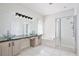 Bright bathroom featuring glass bowl sinks, vanity, shower and soaking tub at 1034 Alvina Ln, Oviedo, FL 32765