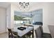 Bright dining area with a pool view, modern light fixtures, and an inviting atmosphere at 1034 Alvina Ln, Oviedo, FL 32765