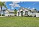 Lovely home with well-kept lawn, complemented by beautiful trees and inviting architecture at 1034 Alvina Ln, Oviedo, FL 32765
