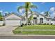 Charming single-story home with a lush front lawn and mature palm trees at 1034 Alvina Ln, Oviedo, FL 32765