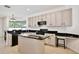 Spacious kitchen featuring modern appliances, an island, and ample cabinet space with black hardware at 1034 Alvina Ln, Oviedo, FL 32765