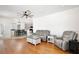 Cozy living room with hardwood floors, modern furniture, and open access to the dining area at 1034 Alvina Ln, Oviedo, FL 32765