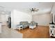 Open-concept living room with modern furniture, hardwood flooring, and a ceiling fan at 1034 Alvina Ln, Oviedo, FL 32765