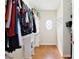 Walk-in closet features custom shelving, storage and wood floors at 1034 Alvina Ln, Oviedo, FL 32765