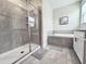 Beautiful bathroom with a walk-in shower, garden tub, and ceramic tile flooring at 1077 Leader St, Davenport, FL 33896